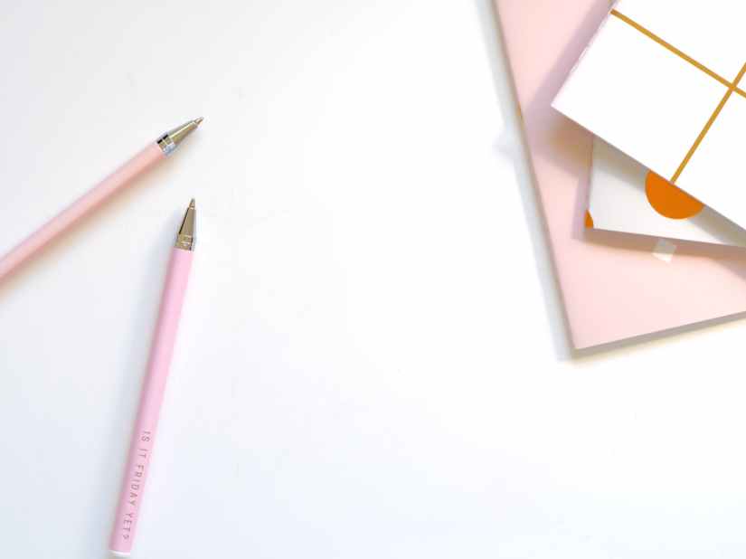 two pink ballpoint pens on table